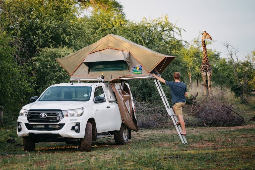 Hilux with rooftop tent set up for camping